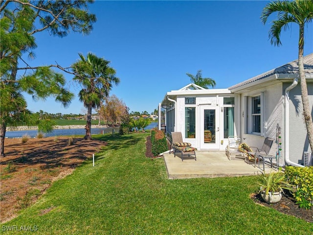 view of yard featuring french doors and a patio