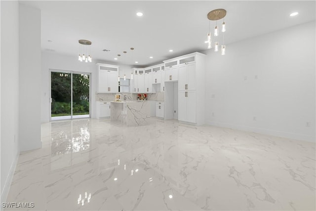 unfurnished living room with marble finish floor, baseboards, and recessed lighting