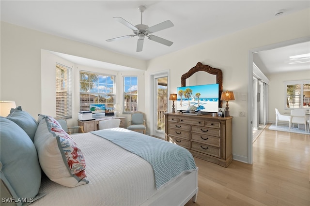 bedroom with a ceiling fan, access to exterior, baseboards, and light wood finished floors