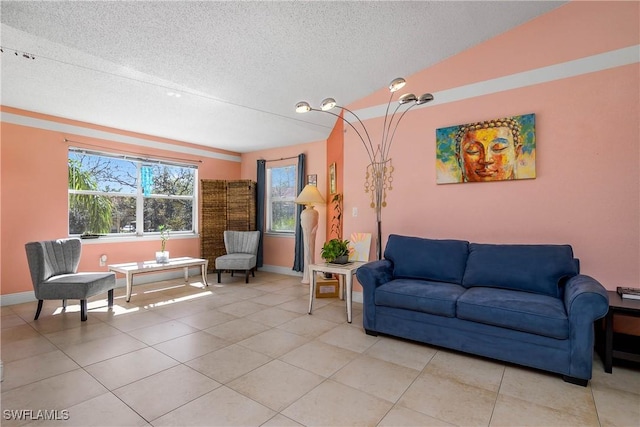 living room with a textured ceiling, light tile patterned floors, and baseboards