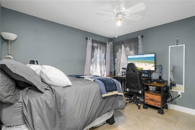 bedroom featuring a ceiling fan and baseboards