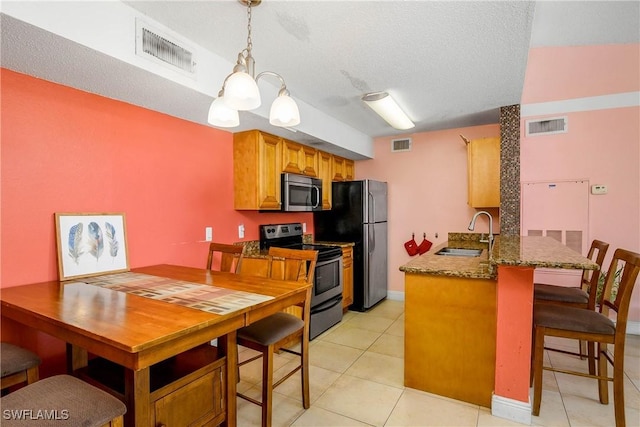 kitchen with appliances with stainless steel finishes, a sink, and visible vents