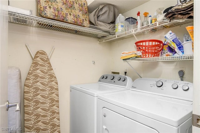 clothes washing area with laundry area and washing machine and clothes dryer