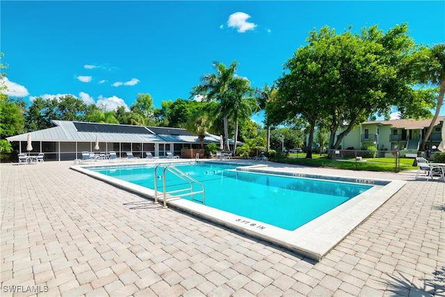 pool featuring a patio and fence