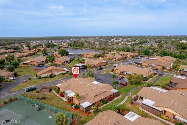 birds eye view of property with a water view and a residential view