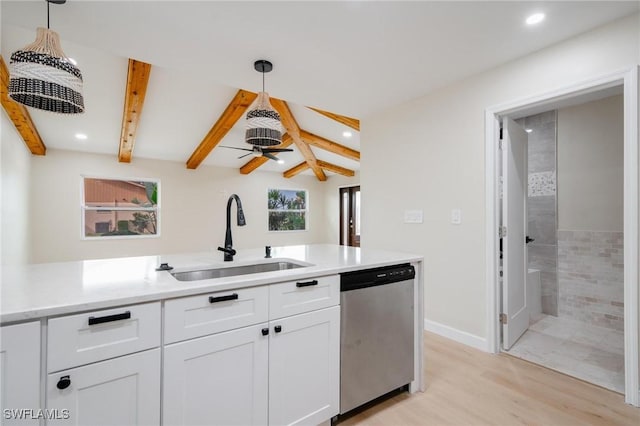 kitchen featuring white cabinets, decorative light fixtures, beam ceiling, stainless steel dishwasher, and a sink