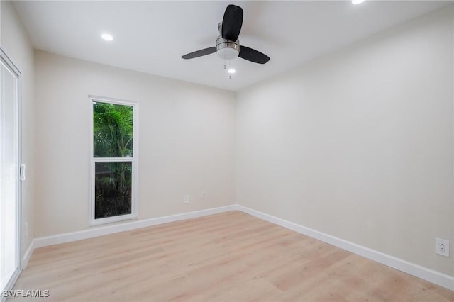 spare room featuring light wood-style floors, baseboards, a ceiling fan, and recessed lighting