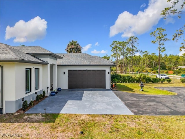 view of home's exterior featuring stucco siding, driveway, a yard, a shingled roof, and a garage