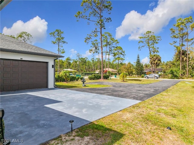 exterior space with a garage, a yard, and driveway