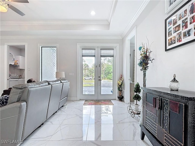 interior space with french doors, marble finish floor, ornamental molding, and washing machine and clothes dryer