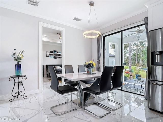 dining space featuring visible vents, marble finish floor, and crown molding