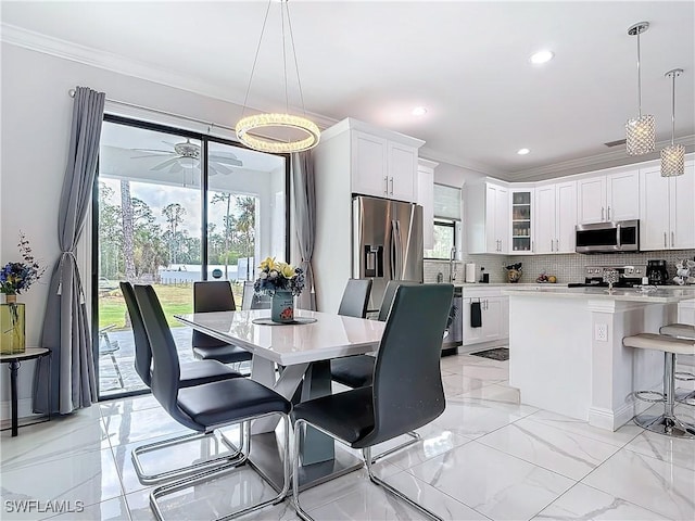 dining space with crown molding, recessed lighting, marble finish floor, and ceiling fan