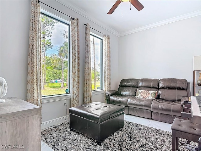 living area with crown molding, baseboards, and ceiling fan