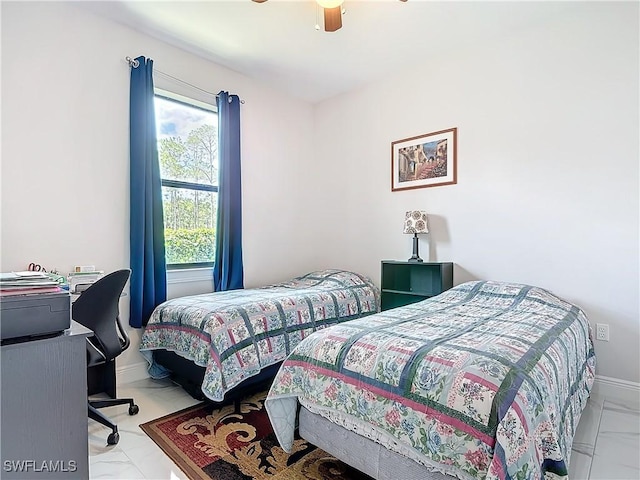 bedroom with marble finish floor, a ceiling fan, and baseboards