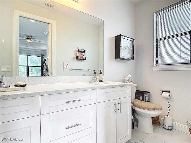 bathroom with double vanity, visible vents, toilet, and a sink