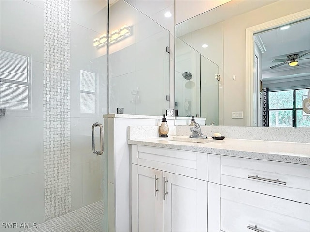 bathroom featuring a stall shower, vanity, and ceiling fan