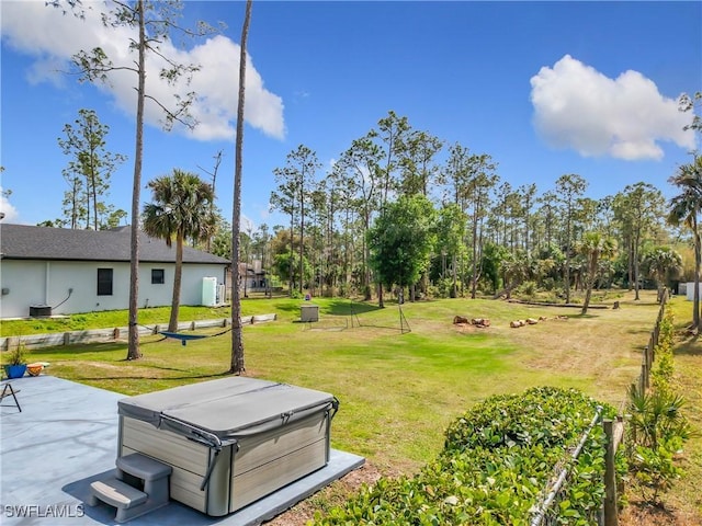 view of yard with cooling unit, a patio area, and a hot tub