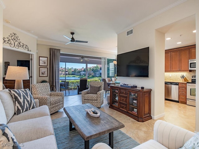 living area featuring light tile patterned floors, a ceiling fan, visible vents, and ornamental molding