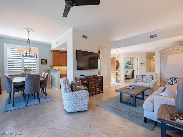 living room with light tile patterned floors, ceiling fan with notable chandelier, visible vents, and ornamental molding