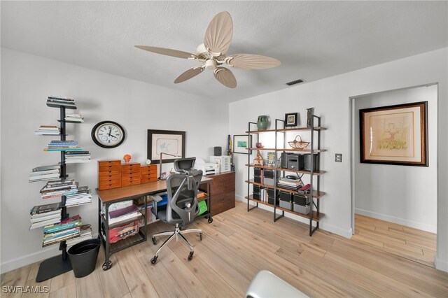 office with visible vents, wood finished floors, a ceiling fan, and baseboards