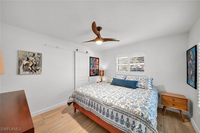 bedroom with ceiling fan, baseboards, and wood finished floors