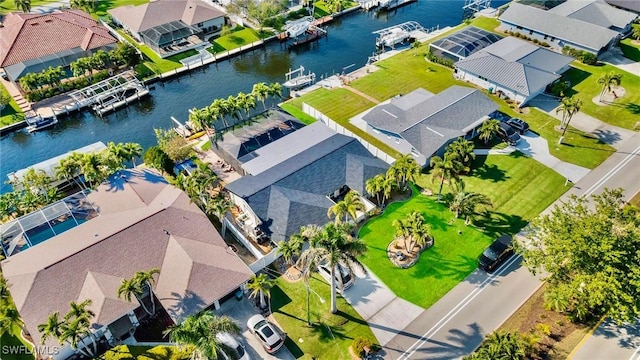 drone / aerial view with a residential view and a water view