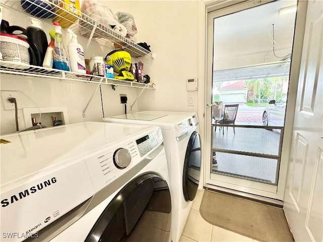 laundry room with laundry area, light tile patterned flooring, and washing machine and clothes dryer