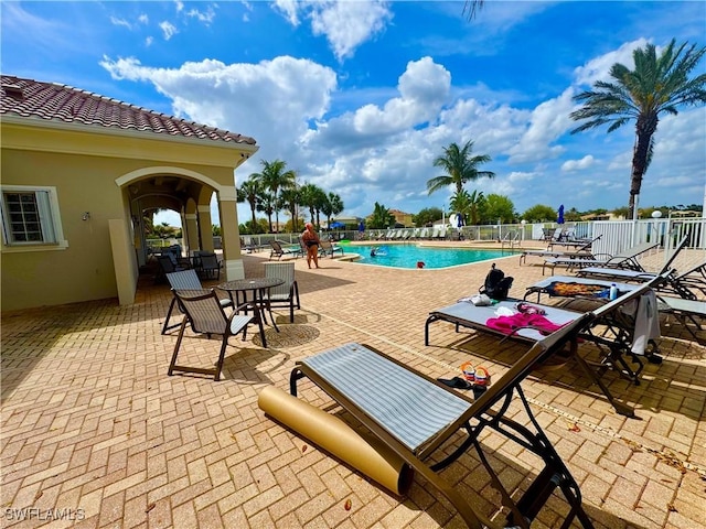 pool featuring a patio area and fence