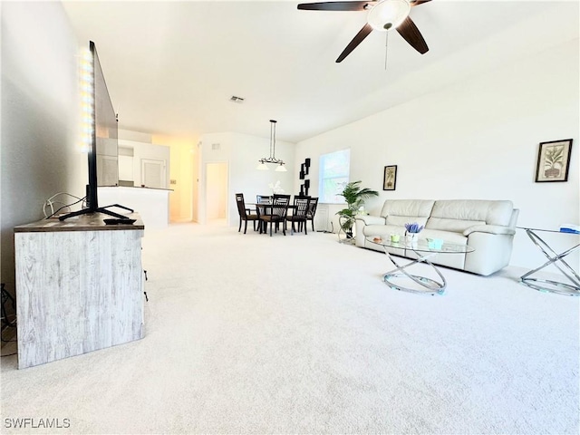 living room with ceiling fan, carpet floors, and visible vents