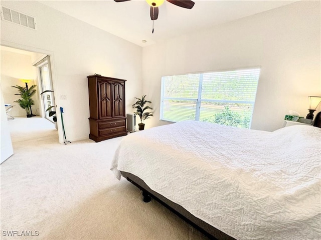 carpeted bedroom with visible vents and a ceiling fan