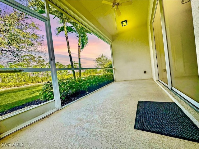 unfurnished sunroom featuring ceiling fan and lofted ceiling