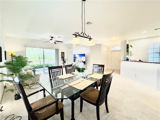 dining area featuring visible vents and light colored carpet