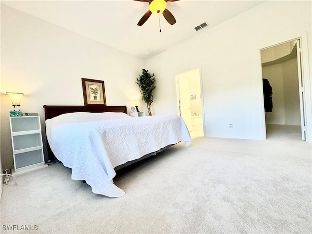 carpeted bedroom featuring ensuite bathroom, ceiling fan, and visible vents