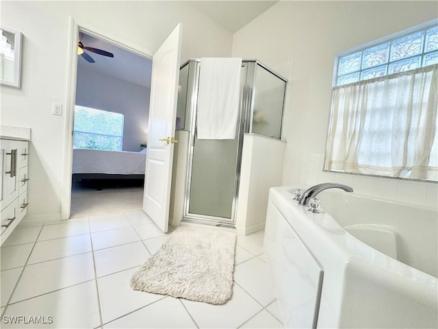 full bath featuring ensuite bathroom, a ceiling fan, a bath, tile patterned floors, and a stall shower