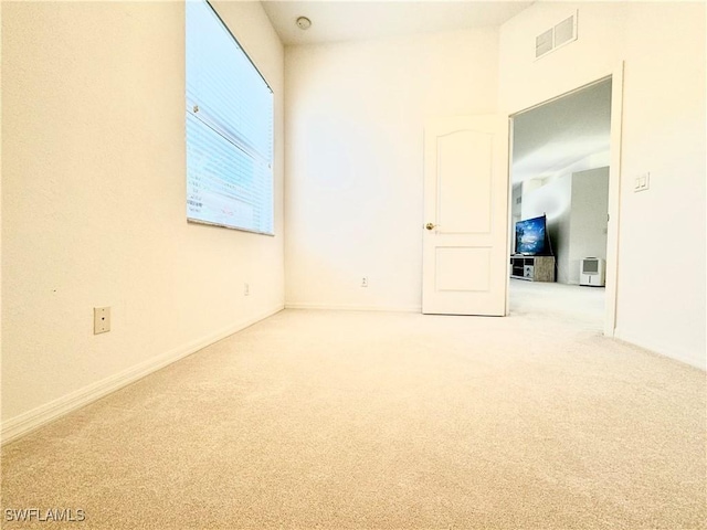 spare room with carpet floors and visible vents