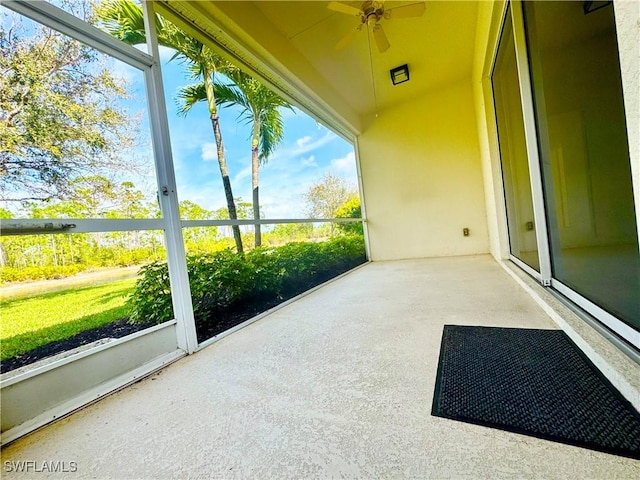 unfurnished sunroom featuring a ceiling fan and lofted ceiling