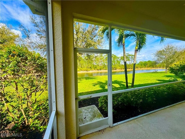 unfurnished sunroom with a water view