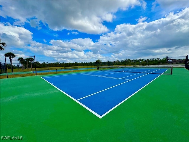 view of sport court featuring fence