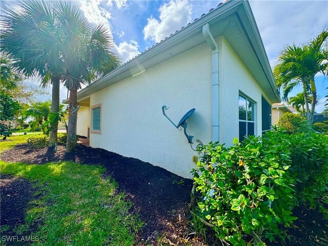 view of side of home featuring stucco siding