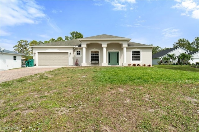 view of front facade featuring a garage, decorative driveway, a front lawn, and stucco siding