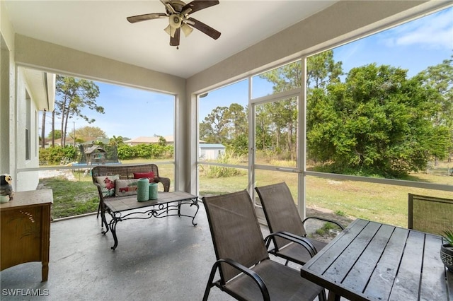 sunroom / solarium featuring a ceiling fan