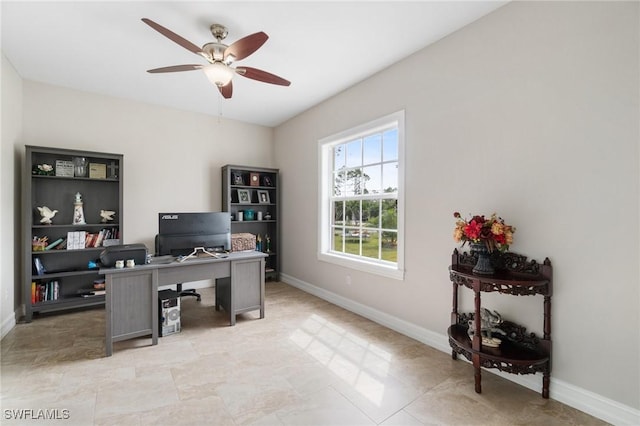 office space featuring baseboards and a ceiling fan