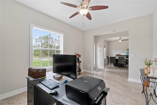 office with a ceiling fan and baseboards