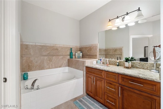 full bath featuring tile patterned flooring, vanity, and a bath