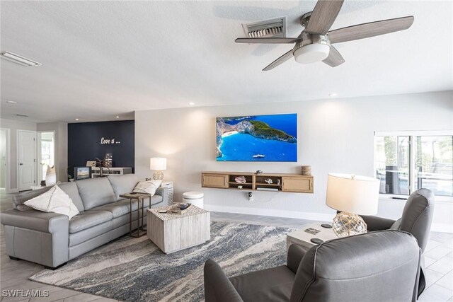 living area with recessed lighting, visible vents, and a healthy amount of sunlight