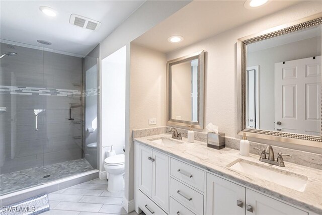 bathroom with a stall shower, a sink, and toilet