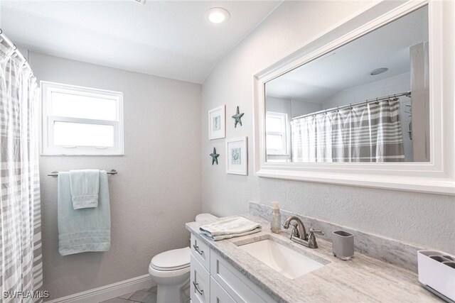 bathroom featuring toilet, baseboards, a shower with shower curtain, and vanity