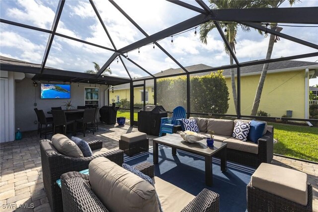 view of patio with an outdoor hangout area, glass enclosure, outdoor dining space, and grilling area