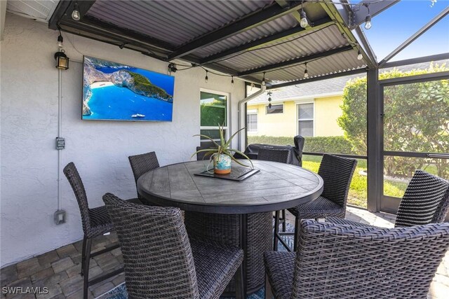 exterior space featuring glass enclosure and outdoor dining space