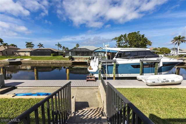 dock area with a yard and a water view